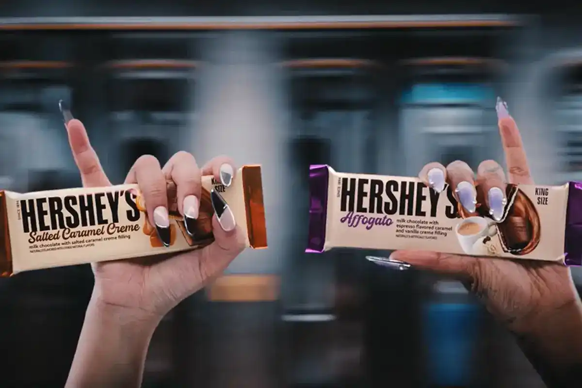 women holding hersheys salted caramel creme and affogato candy bars with their pinkies up