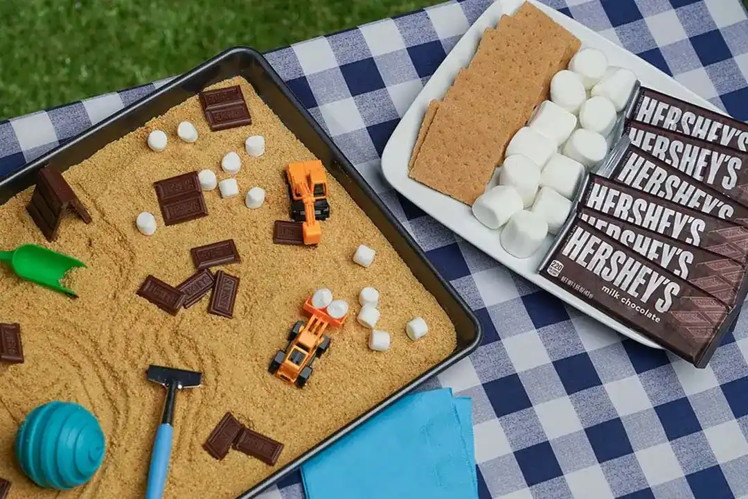 enjoying hersheys smores sensory bin outdoors