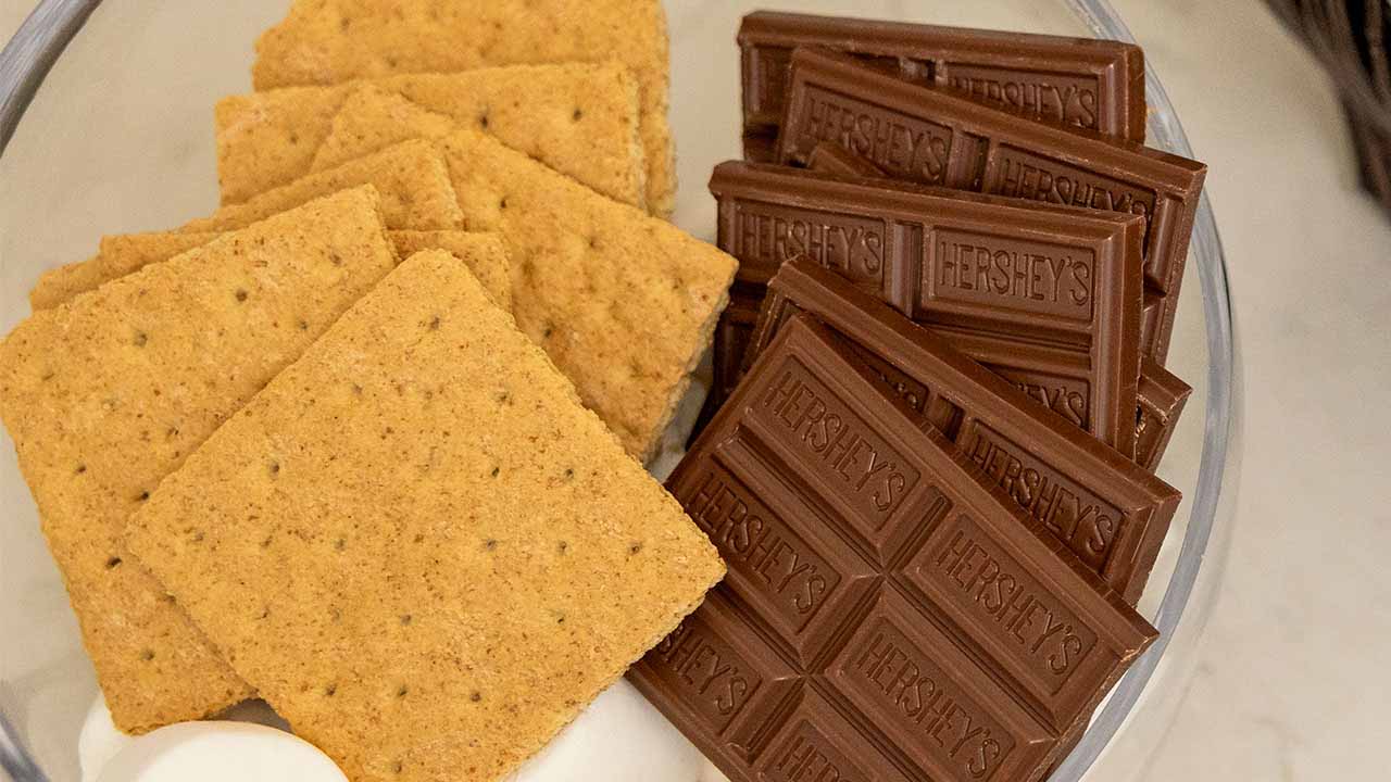 marshmallows, graham crackers, and hersheys milk chocolate bars in a glass bowl