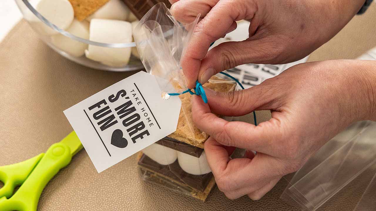 attaching a favor tag to the bag using ribbon or twine