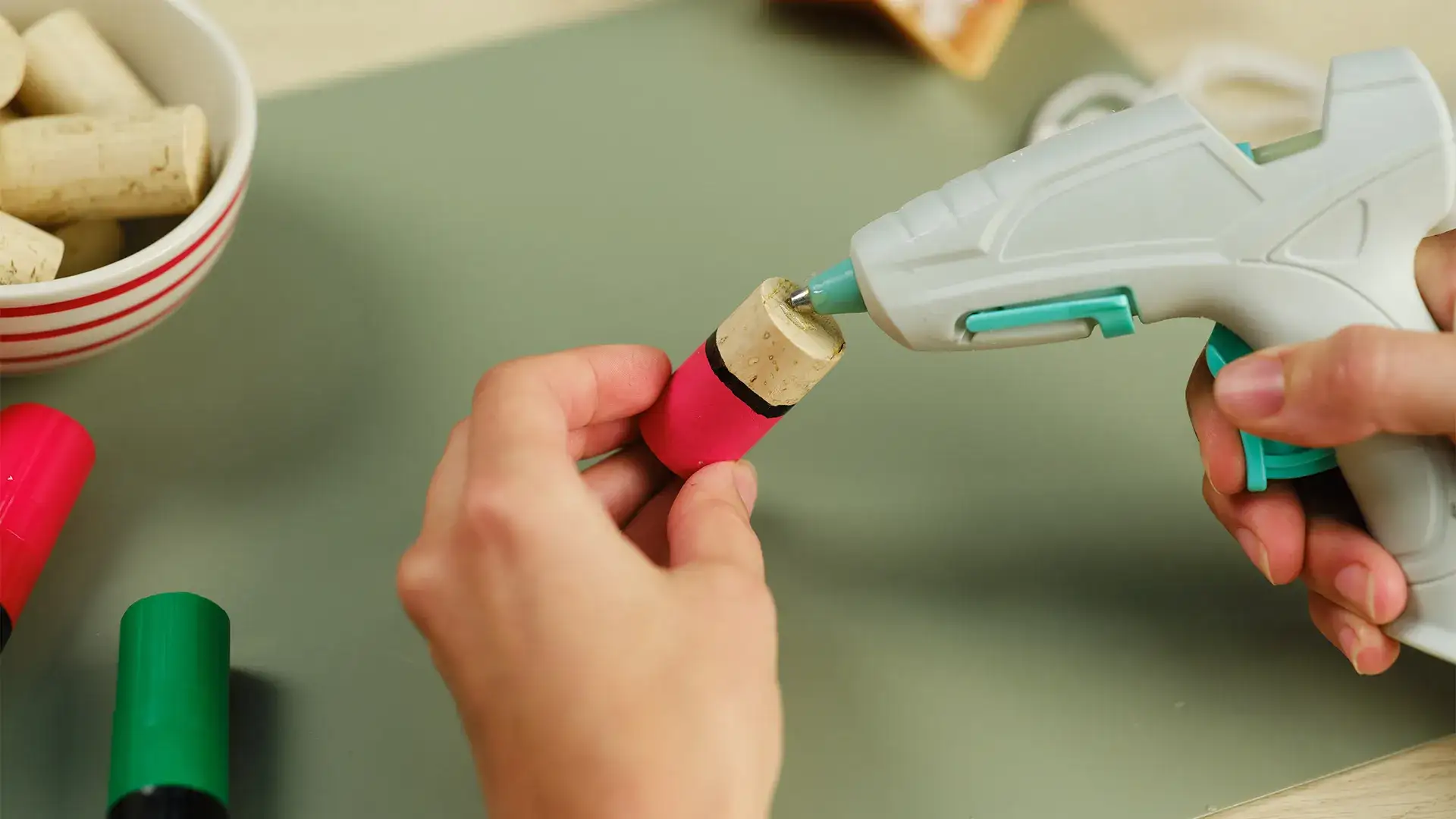 Hot glue being applied to a cork
