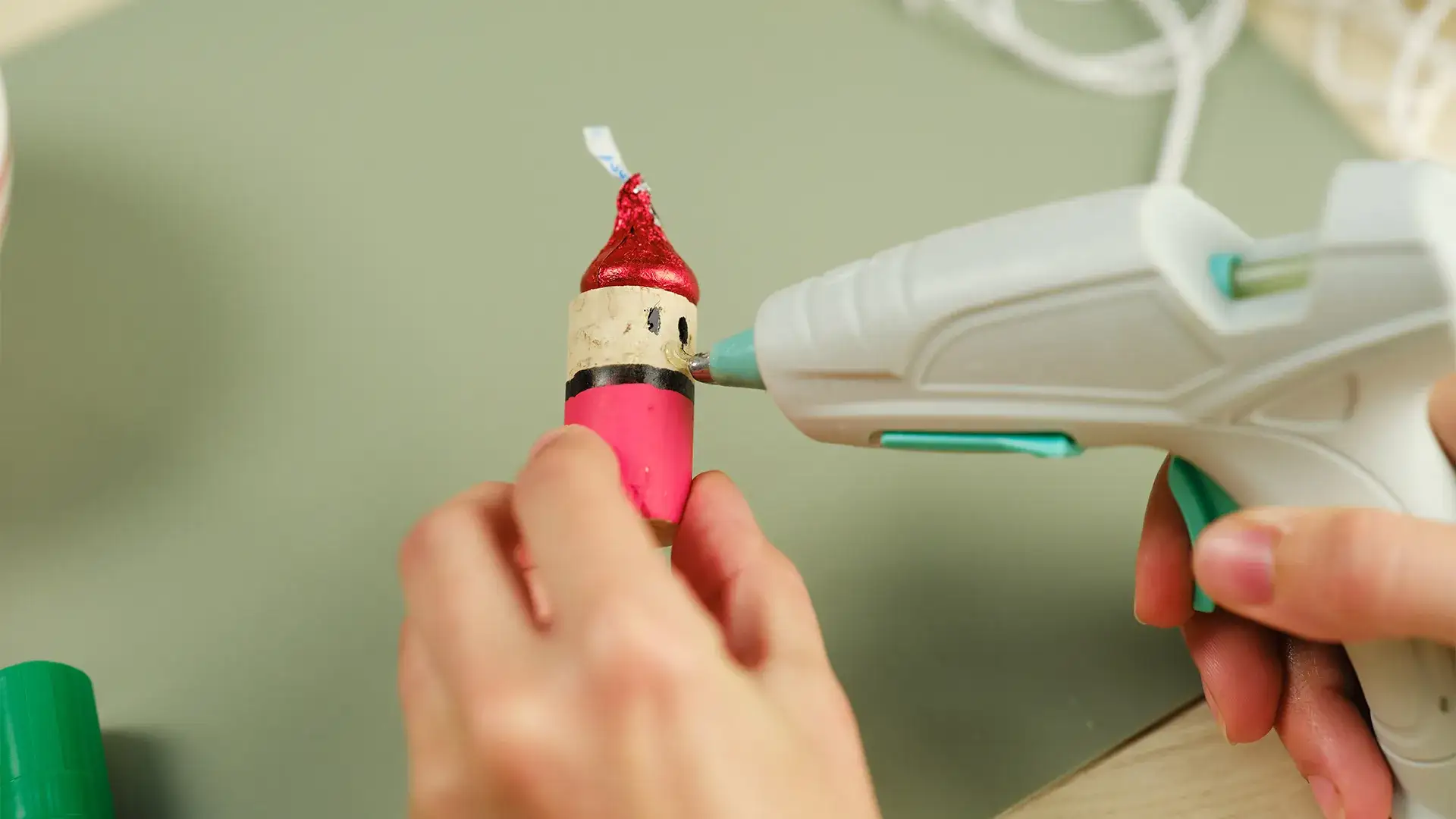 Hot glue being applied to add a nose